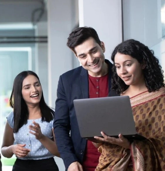 Collaborative team members at Nexa Business Solutions, the Best Digital Marketing Agency India, engaging in strategic project discussions and technical work over laptops